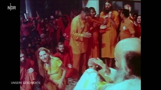 still 00m 28s. Sannyasins touching feet of Bhagwan