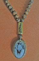 Old mala set in wood and a gold commune pendant