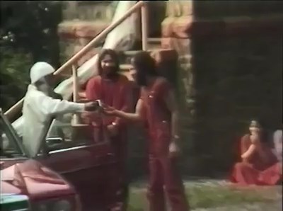 File:Osho at Chidvilas (1981) ; still 05min 07sec Swami Prem Asheesh standing right.jpg