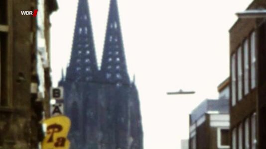 still 00m 02s. Shows Cologne’s Cathedral