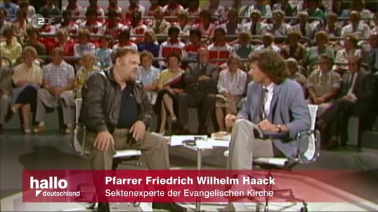 still 04m 34s. TV-interview with christian priest Wilhelm Haack talking against Bhagwan