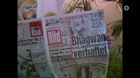 still 1h 18m 52s. Shows german newspaper „Bild“ with info about Bhagwan’s arrest