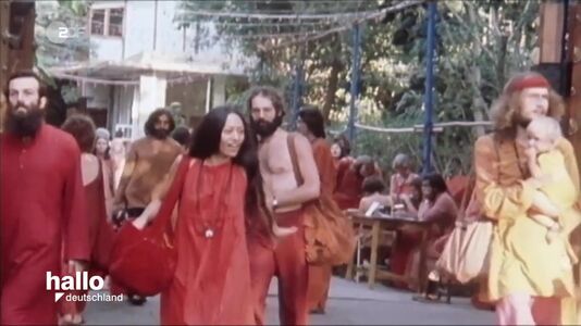 still 04m 09s. Showing scene inside of Poona Ashram 1970s
